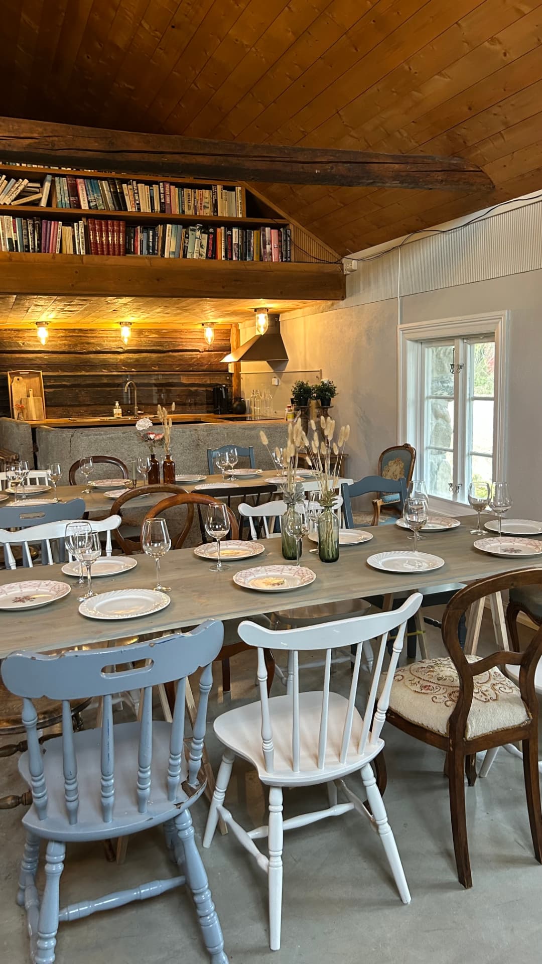 Fjøset – a set long table with mixed chairs