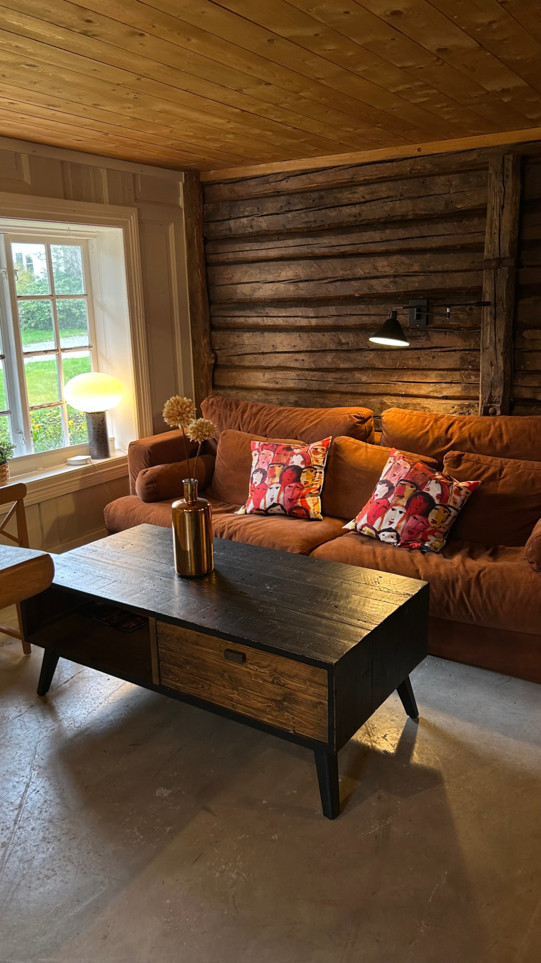 Sofa corner against a log wall