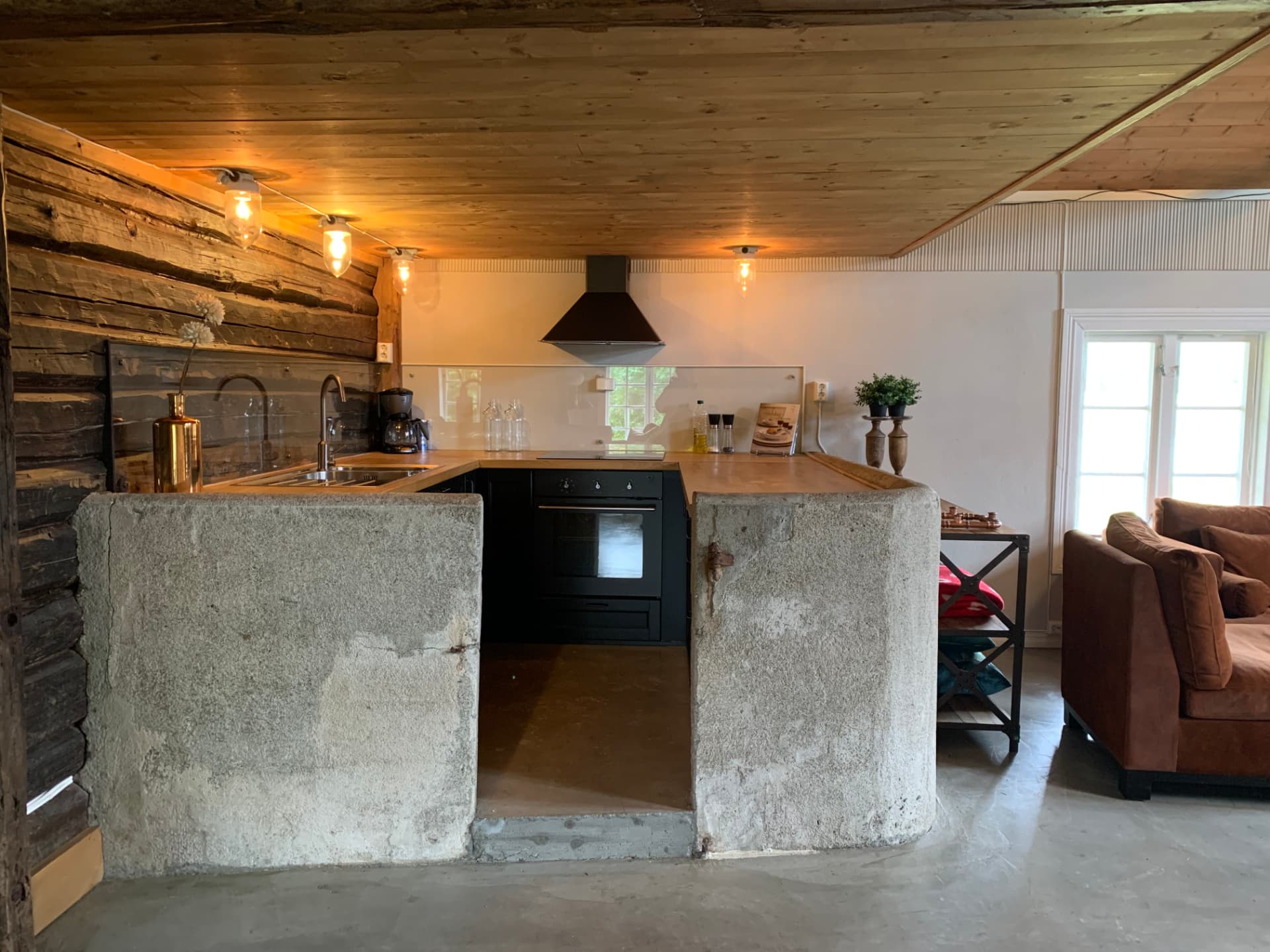 Kitchen with concrete counter and log wall