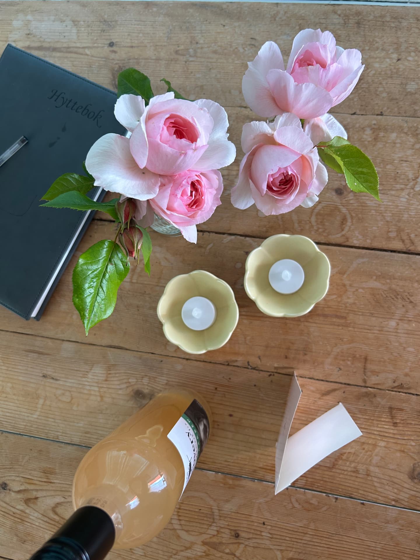 Roses and a cabin book on the table