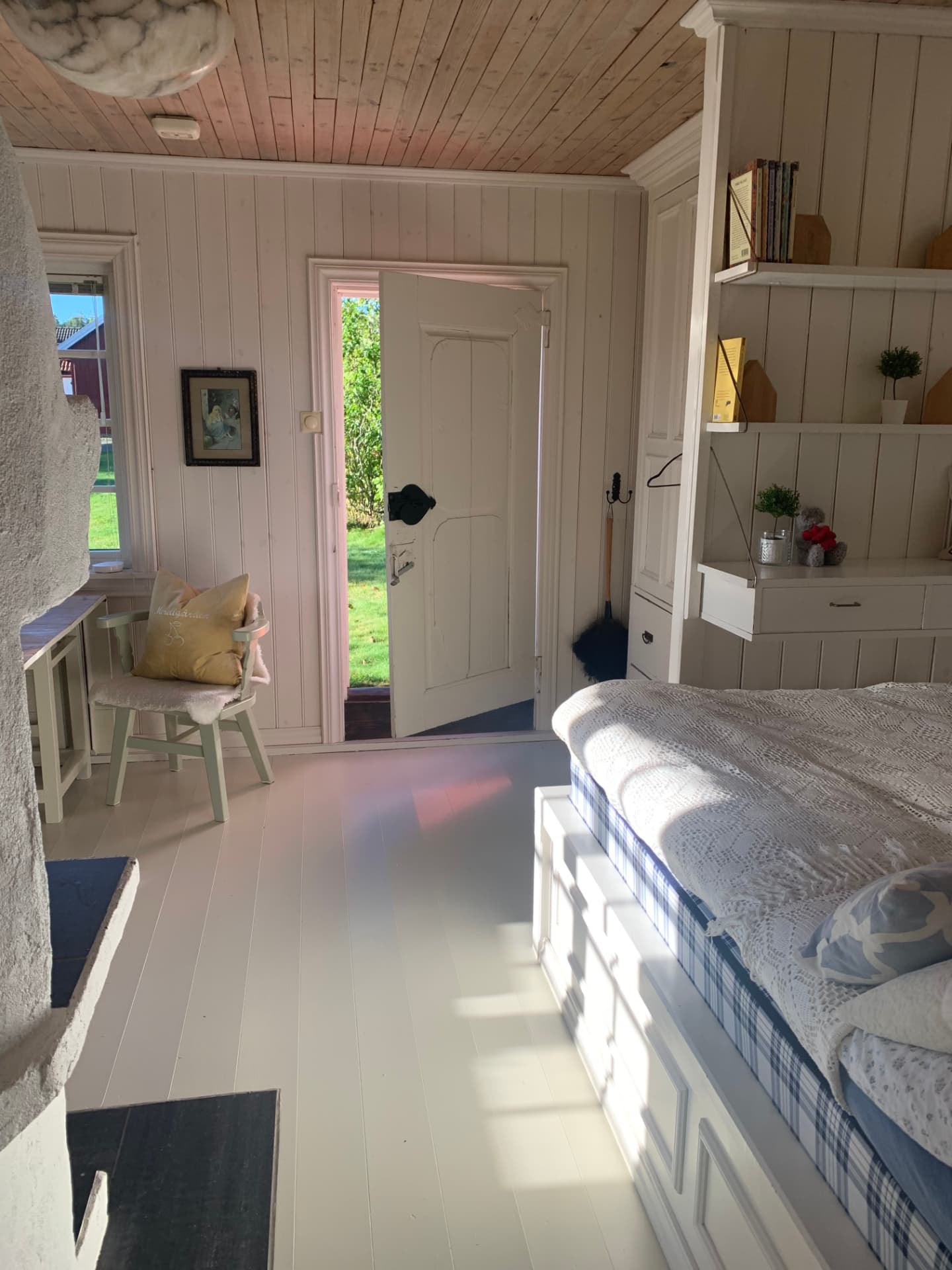 Bright living room with daybed and open door to the garden